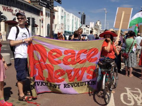 The Peace News banner on a march in Hastings, held by Gabriel Carlyle (left) and Emily Johns (right). Photo: Milan Rai